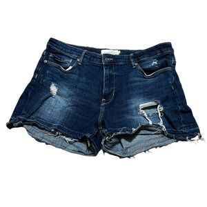 Blue denim shorts with a distressed look